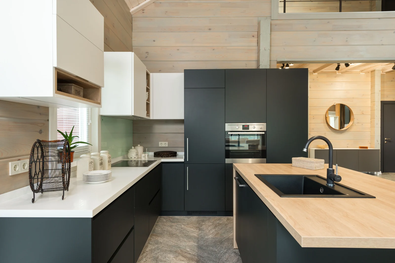 Charcoal slab cabinetry with an oak-topped island