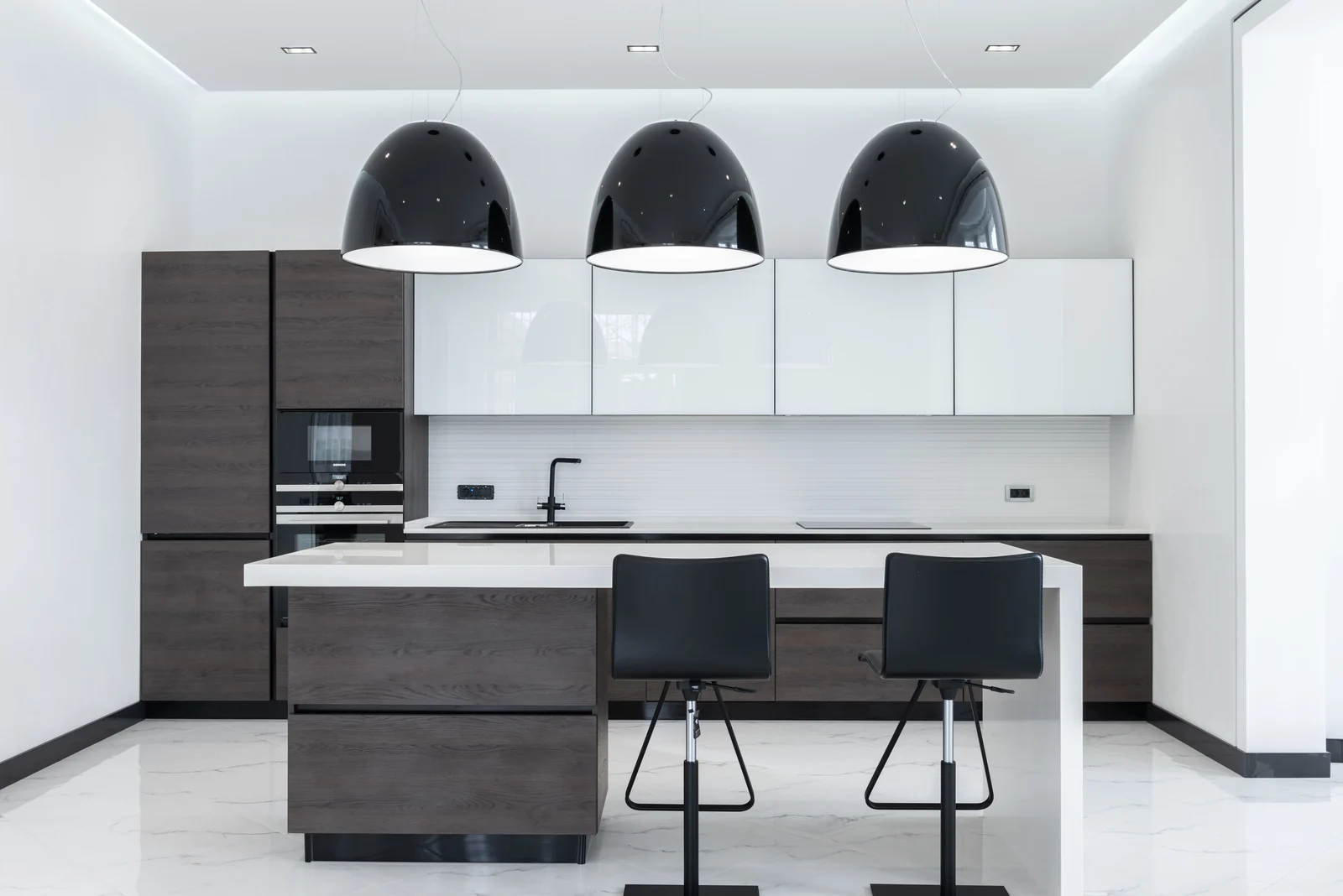 Dark wood and white gloss cabinetry around a seated island