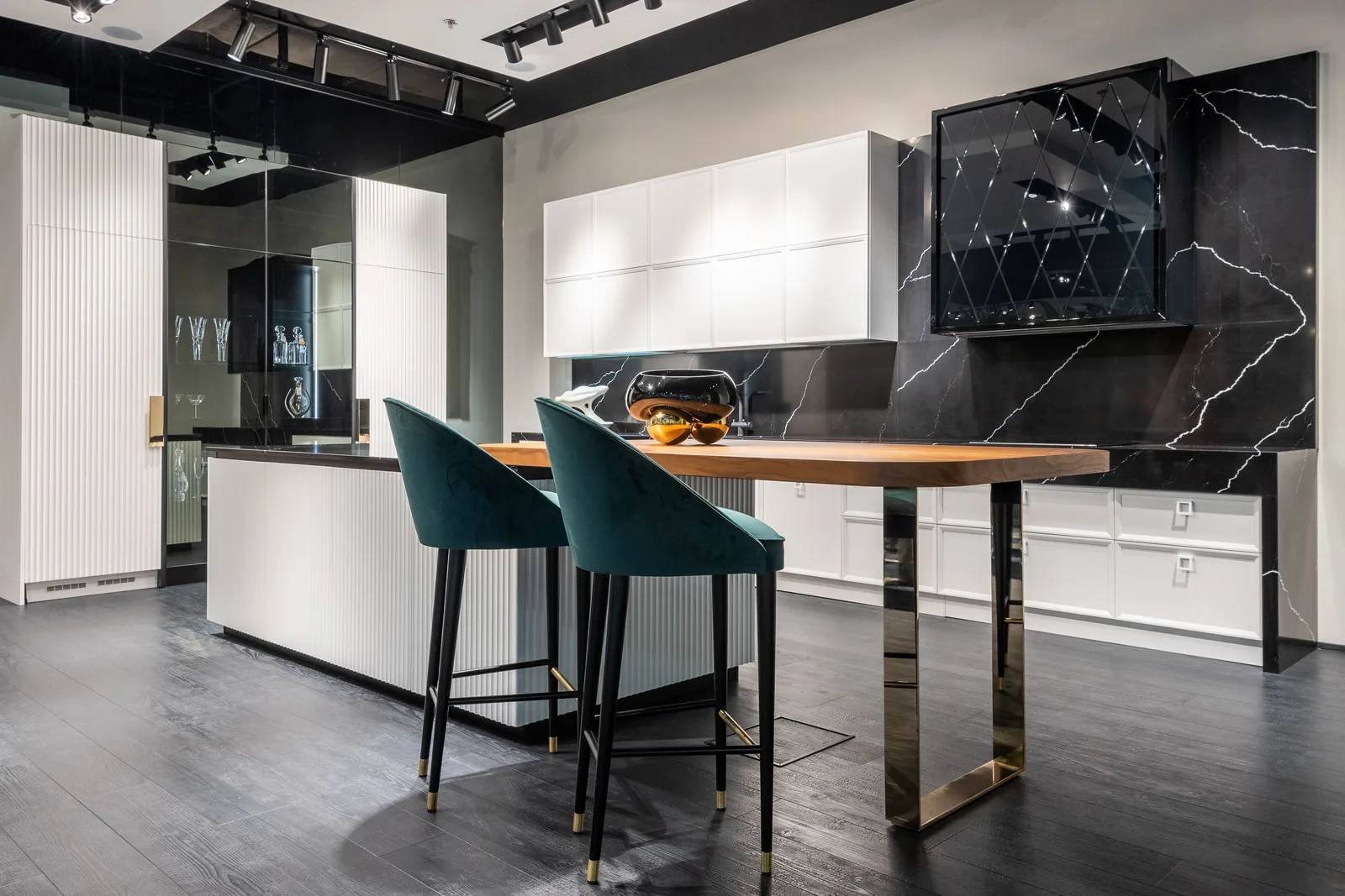 A white fluted island and black marble surround in a showroom