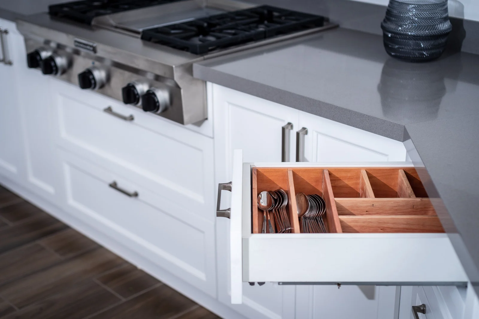A white shaker drawer open showing a wooden cutlery divider