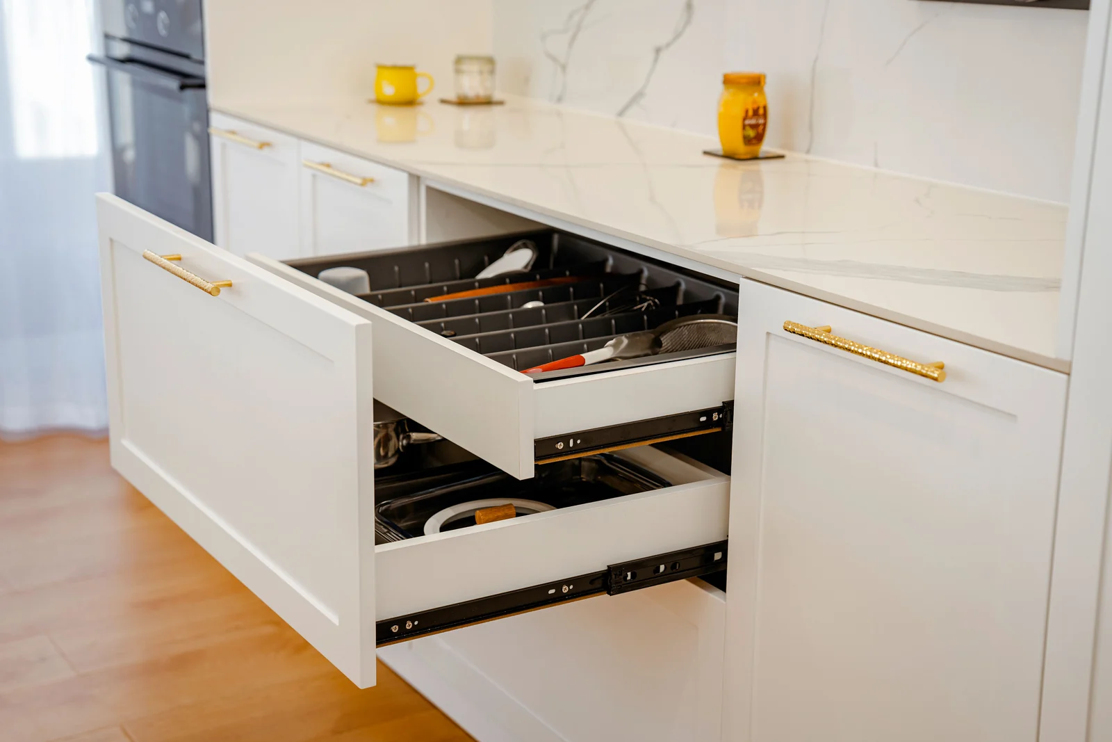 White shaker drawers open on runners with a cutlery insert